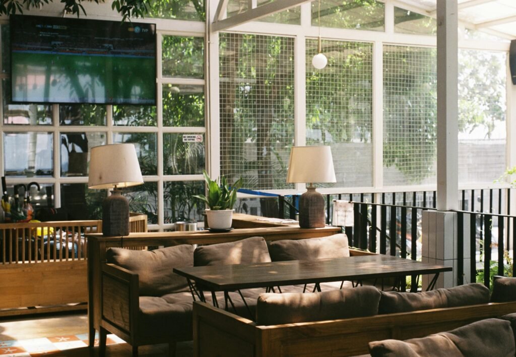 Inviting patio area with comfortable sofas, lamps, and a television, perfect for relaxation.